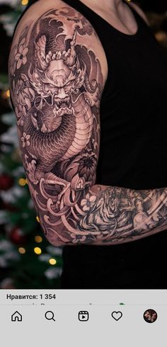 a woman with a dragon tattoo on her arm and chest, standing in front of a christmas tree