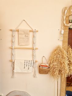 a room with a bed, basket and wall hangings on the wall next to it