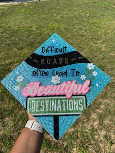 a blue graduation cap with the words, difficult roars often lead to beautiful destinations