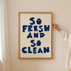 a woman standing in front of a poster that says so fresh and so clean