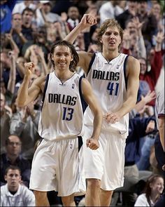 there are two men that are standing in the middle of a court with their hands up