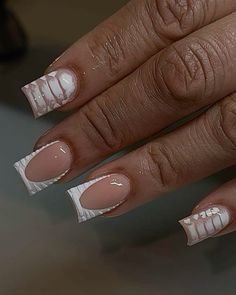 a woman's hand with french manies and white laces on her nails