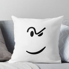 a white pillow with a smiley face drawn on it