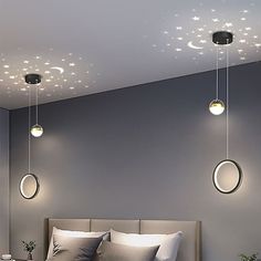 a bedroom with three round lights hanging from the ceiling