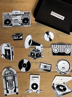 some stickers are laying on a table next to a record player and an old radio