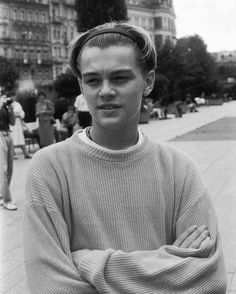 black and white photograph of a young man with his arms crossed