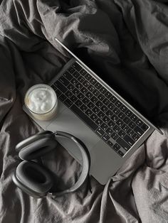 an open laptop computer sitting on top of a bed next to a stethoscope