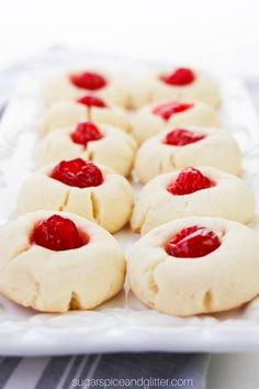 small cookies with raspberry filling on a white plate