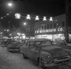 an old photo of cars parked in the snow