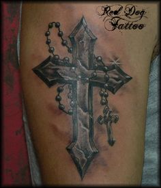 a black and white photo of a cross tattoo