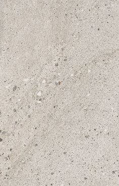 the texture of concrete is white and has small rocks on it, as well as pebbles