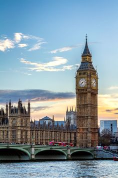 the big ben clock tower towering over the city of london, england at sunset or dawn