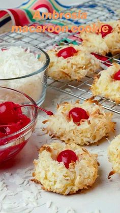 coconut cookies with cherries are cooling on a rack next to a bowl of rice