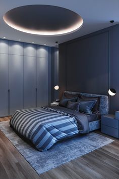 a bedroom with blue walls and wooden flooring has a circular light fixture above the bed