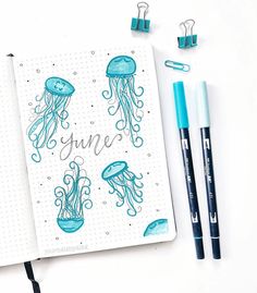 an open notebook with jellyfish and the word june written in cursive writing