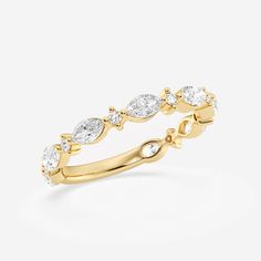 a yellow gold ring with three pear shaped diamonds