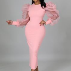 a woman wearing a pink dress with long sleeves and ruffles on the shoulders