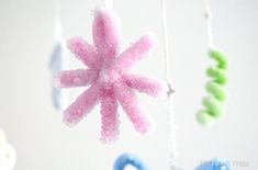 an ornament hanging from a string in the shape of a snowflake