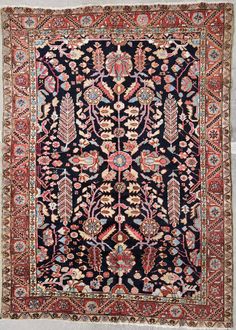 an antique persian rug with floral design