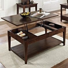 a coffee table with an open drawer underneath it