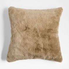 a brown pillow on top of a white wall