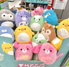 a bunch of stuffed animals are in a box on the store shelf and ready to be sold