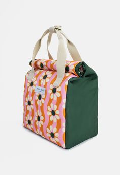 an orange, pink and green bag with white flowers on it's front pocket