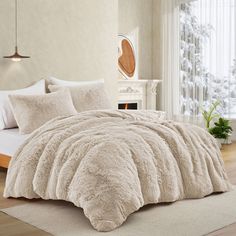 a bed with white comforter and pillows in a bedroom