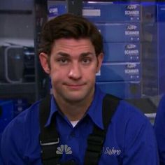 a man in a blue shirt and black suspenders