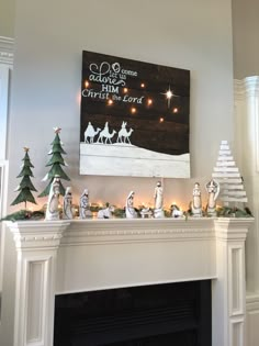 a fireplace with christmas decorations on it and a nativity scene above the mantel