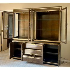 an entertainment center with glass doors and drawers