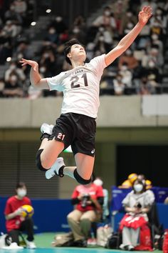 a person jumping in the air with a tennis racket