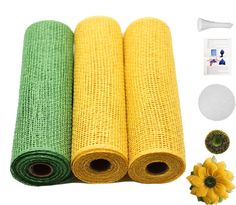 three rolls of green and yellow mesh fabric next to each other with flowers in the background