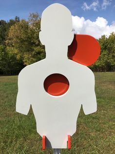 a sculpture in the shape of a man with two red circles on his chest and back