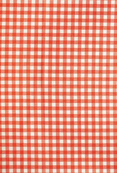 an orange and white checkered tablecloth with some black dots on the bottom half