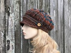 "Style: Chunky newsboy hat. It features a sturdy brim and a strap and handmade wooden buttons. Color: This sample hat is shown in Chocolate Peacock, shades from brown to rust and teal blue. Note: The coloration of these hats come out a little different every time, due to the striped nature of the yarn. If you would like photos of the exact hat that I make for you, feel free to ask, I will be happy to provide them. Sizes: One size fits 20\" to 23\" (50.5 cm to 58 cm) head size. Fiber Content: 100 Hand Knitted Adjustable Hat For Fall, Multicolor Flat Cap For Fall, Adjustable Crochet Hat With Short Brim For Fall, Brown Crochet Cap, Brown Crochet Hat With Short Brim, Hand Knitted Brimmed Hats For Fall, Handmade Brown Flat Cap, Slouchy Cap For Fall, Slouchy Fall Cap Hat