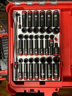 a red toolbox filled with lots of different types of screwdrivers and tools