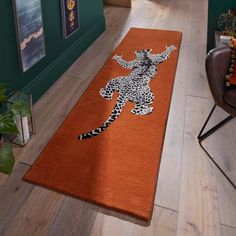 an orange rug with a drawing of a leopard on it