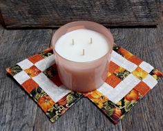 a candle sitting on top of a place mat