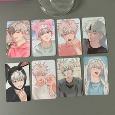 six coasters with anime characters on them sitting next to a wine glass and cup