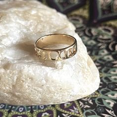 a gold ring sitting on top of a rock