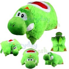 the green stuffed animal is laying on its side and has four different faces, including one with