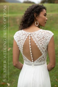 the back of a woman's wedding dress with pearls on it and an open neckline