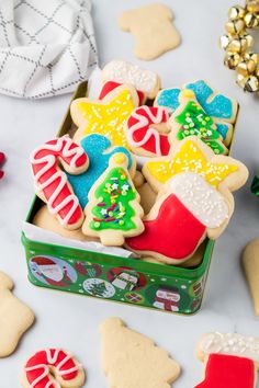 decorated christmas cookies in a box on a table