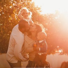 a family is posing for a photo in the sun