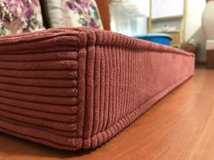 a close up view of a bed with red bedspread