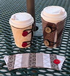 two coffee cups sitting next to each other on a table