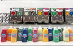 bottles of juice are lined up in front of machines