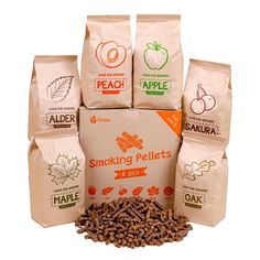 a pile of coffee beans sitting next to bags of apple and maple flavored coffee