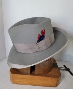 "Elevate your style with this beautiful vintage Knox's wide brimmed fedora hat. Crafted from high-quality materials, this hat is the perfect addition to any wardrobe. With its classic design and versatile color, make it a must-have for any fashion-forward individual who wants to make a statement. Its timeless design and superior craftsmanship ensure that it will be a staple in your wardrobe for years to come. Invest in this vintage accessory today and add a touch of sophistication to your look. Custom Formal Hat With Short Brim, Custom Adjustable Fedora For Formal Occasions, Adjustable Fedora For Formal Occasions, Custom Wide Brim Fedora For Formal Occasions, Formal Wide Brim Fedora, Custom Formal Hat For Kentucky Derby, Custom Hat For Kentucky Derby, Classic Fitted Gray Fedora, Classic Gray Fedora